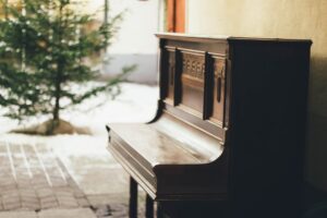 brown wooden upright piano in shallow focus lens